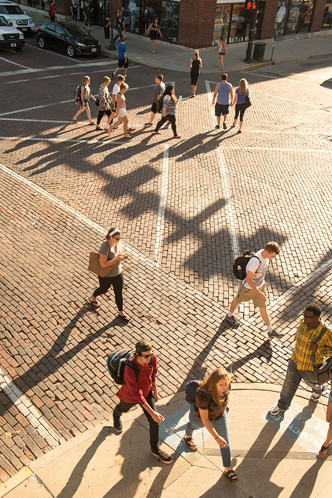 Students zig-zag across the diagonal crosswalks at the intersection of Court Street and Union Street.