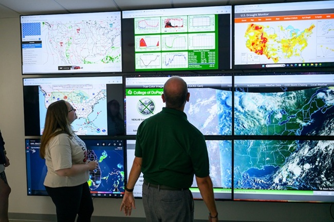 Ryan Fogt and an OHIO student look at weather screens as part of the meteorology class