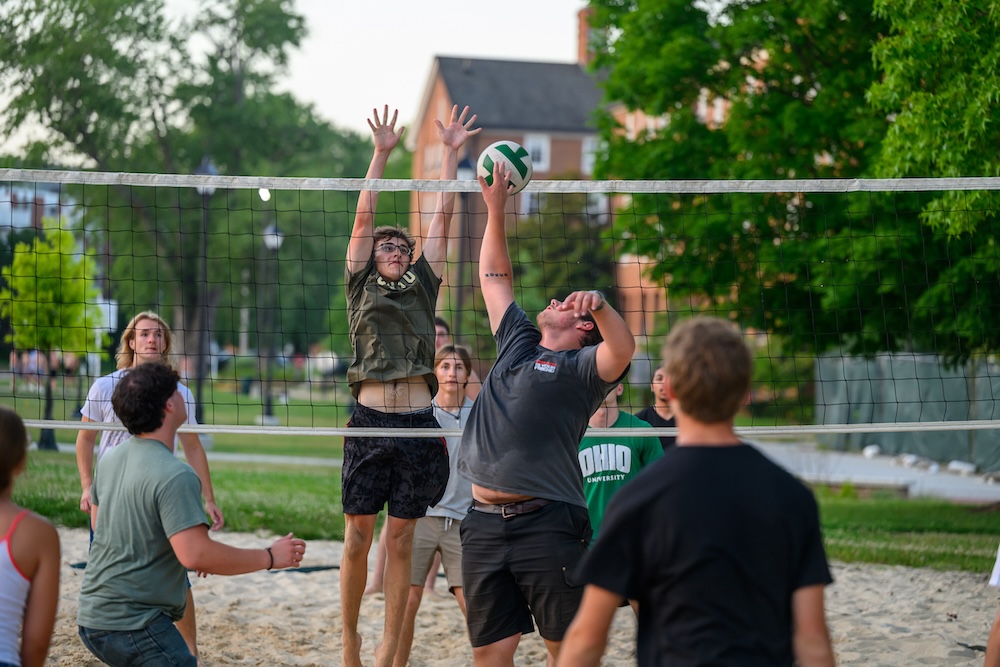 students play volleyball