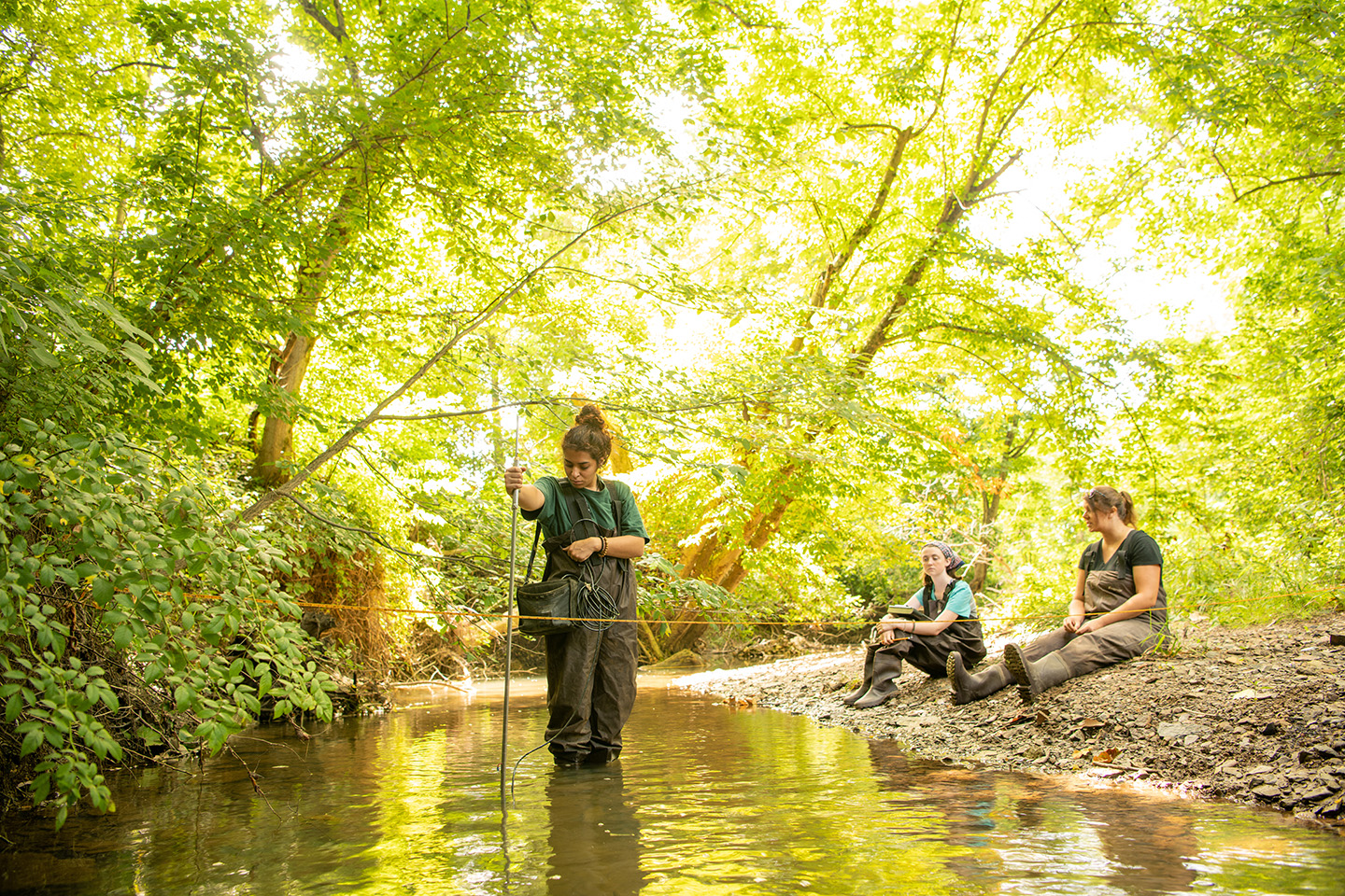 Students with the Voinovich School of Leadership and Public Service test water quality in southeast Ohio.