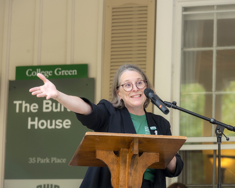 Kristina Bross speaks to the crowd while standing at the podium at the dedication ceremony