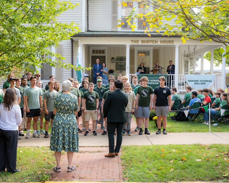 OHIO students sing in front of The Burtch House at the dedication ceremony