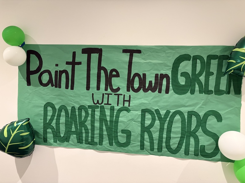a banner that says "Paint The Town Green with Roaring Ryors"