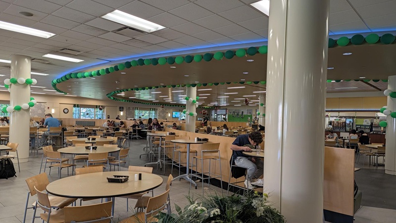 Nelson Commons is decorated with long rows of green and white balloons for Homecoming