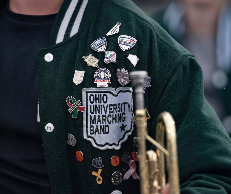 Close-up image of pins and buttons on a Marching 110 jacket