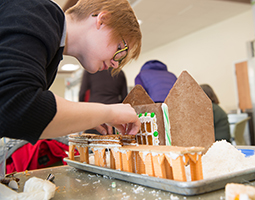 Elana Harnish, an administrative services associate at the Center for International Studies, works on the Office of Global Affairs and International Studies’ gingerbread entry, which won last year’s Gingerbread Contest.