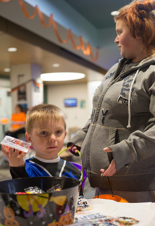 Jasper Hazlett, 4, picks out candy with his mom, Amber Hazlett, during tRAC-or-Treat in James Hall on Oct. 24.