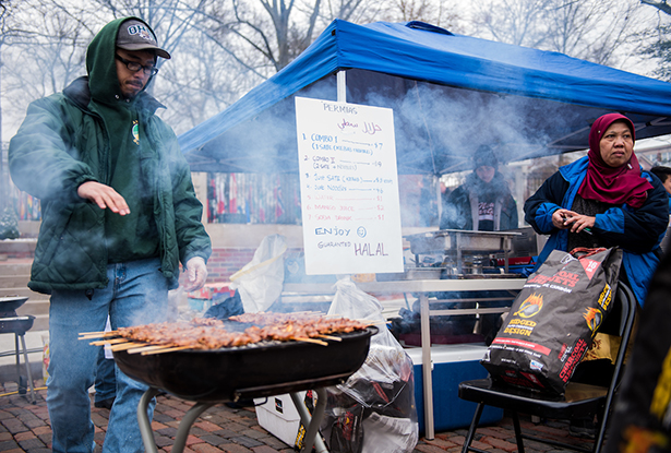 Members of Ohio University’s Indonesian Student Association prepare one of the most popular dishes at the International Street Fair, satay and noodles.