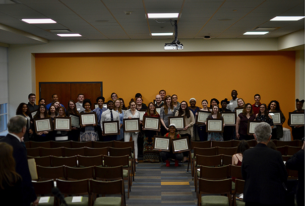 Students from Ohio University residence halls recognized for having combined GPAs of 3.0 or higher pose with the awards they received at the annual President’s Scholarship Reception.