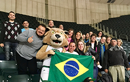 Some of the Brazilian teachers participating in the PDPI Brazil English Teachers Program pose for a photo with Rufus while attending the Ohio University Men’s Basketball game at the Convocation Center on Jan. 16.