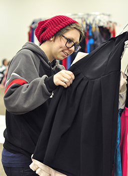 Kelley Johnson picks out a dress for her prom at the 2014 “Sisterhood of the Traveling Dresses” clothing giveaway.