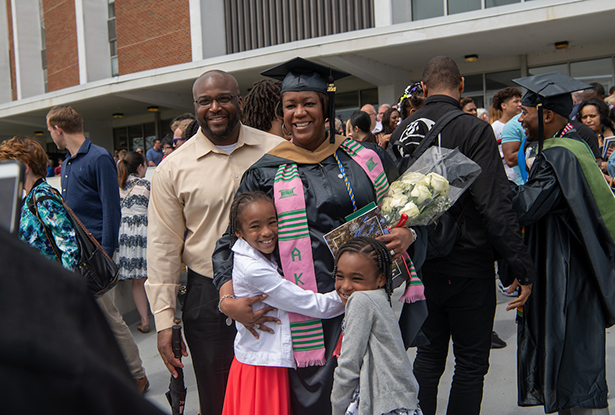 Jada Peterson, who graduated with a master of business administration, poses for a photo with her family outside OHIO’s Convocation Center following the 2018 Graduate Commencement ceremony.