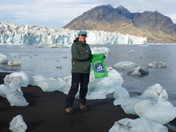 Doctoral student, Nina Adanin, plants The Patton flag at the North Pole.