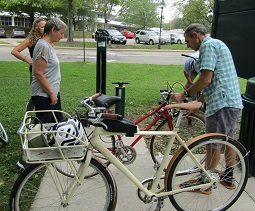 Peter Kotses checks Chris Gabriel's bicycle tires
