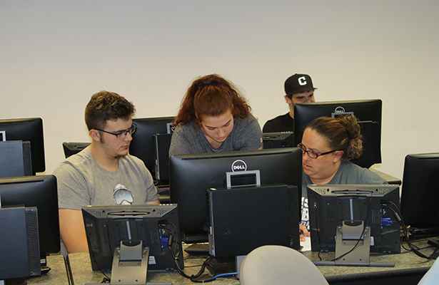 Erika Bentley, Student Assistant for Financial Aid, helps students check their financial aid packages during orientation for fall 2018