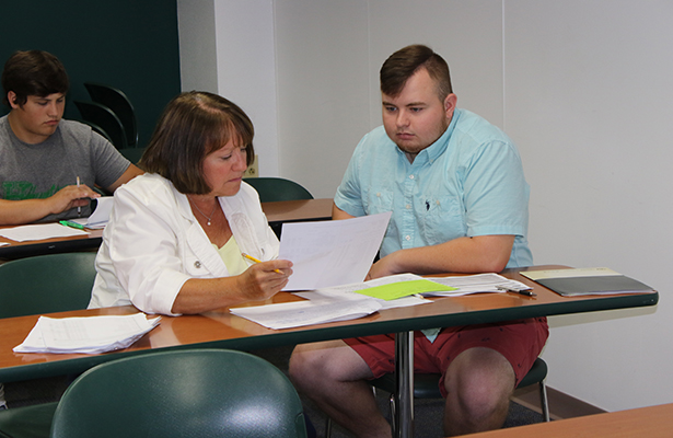 Karen Corcoran, Program Coordinator of Middle Childhood Education, helps students arrange their fall schedule at orientation during summer 2018