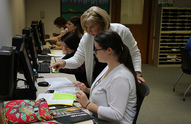 Cristy Null, Coordinator of Academic Advising, assists students with registering for fall 2018 classes during orientation