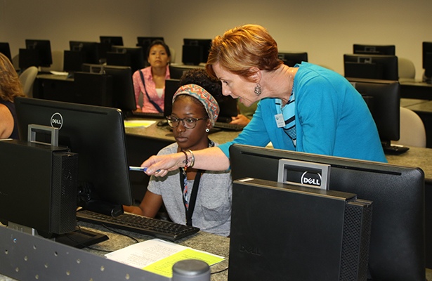 Martha Tanedo, Coordinator of Student Support, assists students with registering for fall 2018 classes at orientation