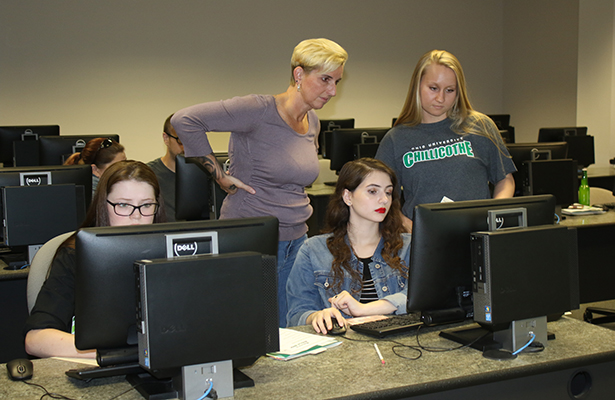 Maria King, Student Assistant for the Hilltopper Advising Center, helps students add classes to their fall 2018 schedule during orientation