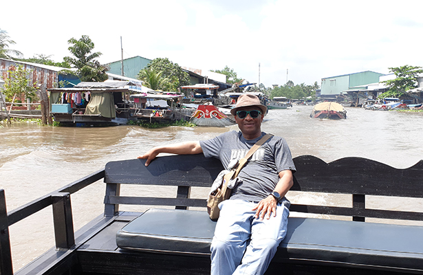 Obi in a boat along the Mekong Delta River in Vietnam