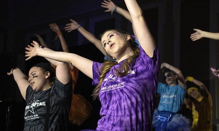 Maura Anderson, morale captain of the Purple Team, performs a dance routine with other morale captains during the opening ceremony of BobcaThon 2019.