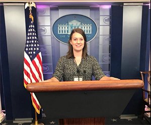 Julia Fair, who completed the Scripps Semester in D.C. program in the fall of 2017, is pictured behind the podium inside the White House press briefing room.