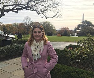 Camille Fine, a photojournalism student who participated in the Scripps Semester in D.C. program this past academic year, is pictured in Washington, D.C., with the Washington Monument in the background.