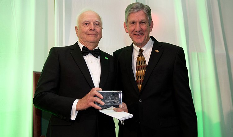 (From left) Bill Dillingham, BBA ’71, poses for a photo with Ohio University Athletic Director Jim Schaus after receiving the 2018 Athletic Director’s Award of Excellence at the Alumni Awards Gala.