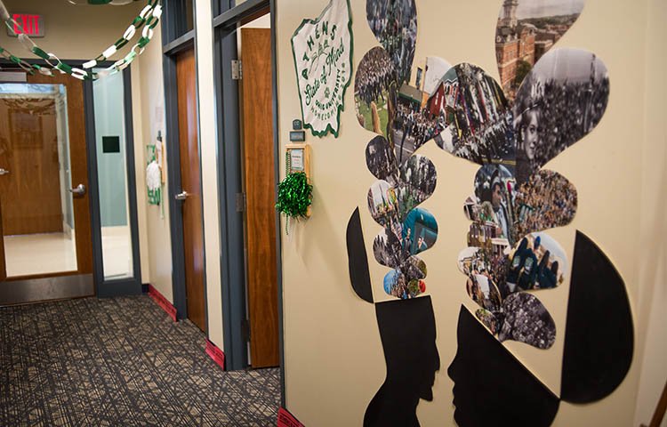 A large “Athens State of Mind” graphic, featuring OHIO Homecoming photos dating back to the 1960s, greets visitors to the Department of Human and Consumer Sciences’ Paint the Town Green display. 