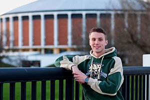 Ford Clark, BBA ’16, poses for a photo in front of the Convocation Center where he served as a resident assistant while studying at OHIO.