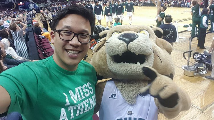 Alex Sheen, founder of “Because I Said I Would,” is all smiles as he poses with Rufus at an Ohio University basketball game.