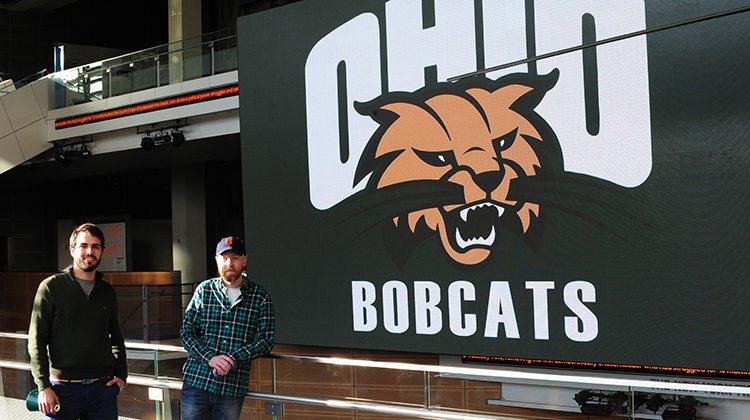 Fellow Bobcats Andrew Logan (left) and Tyler Weymouth pose in front of the Newseum's “big screen,” proudly displaying OHIO’s Attack Cat.