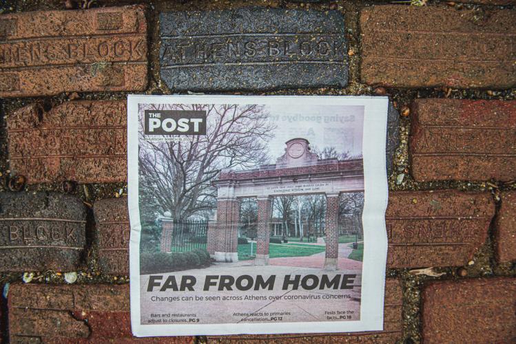 The Post's latest print edition focusing on coronavirus is displayed among the bricks on OHIO's Athens Campus. 