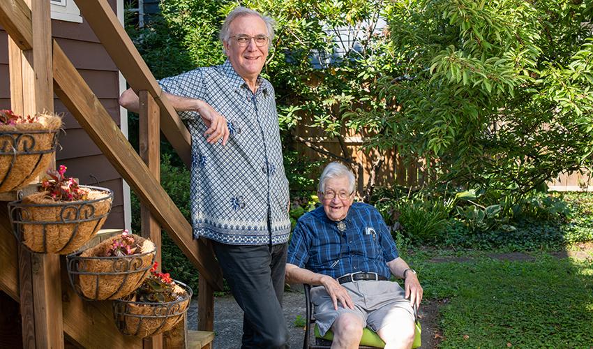 Professors Emeriti Bob Stewart and Hugh Culbertson pose for a photo outdoors.