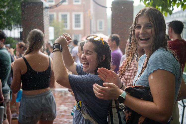 Students outside in the rain at the student involvement fair