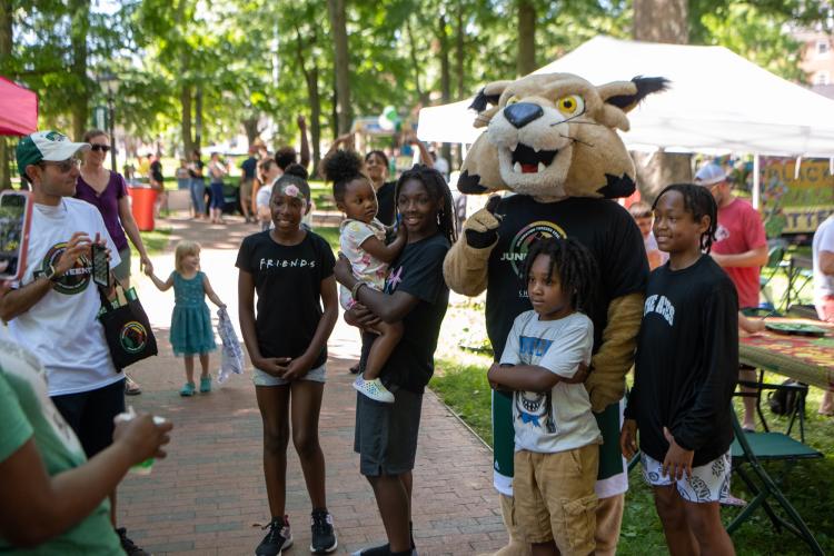 Rufus poses with several individuals at the Juneteenth 2022 celebration