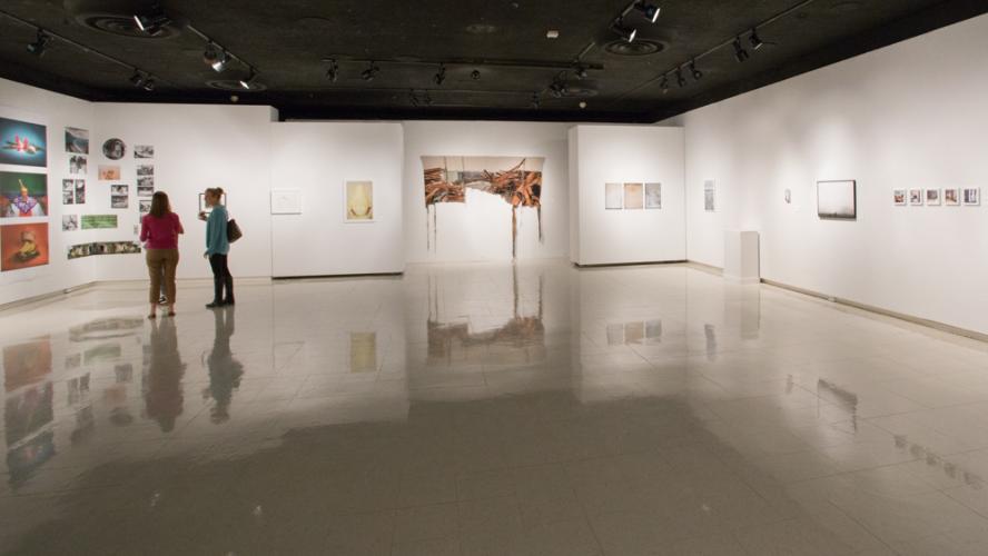 Alternatives Exhibition shot from 2017 showing two figures standing in a large gallery space.