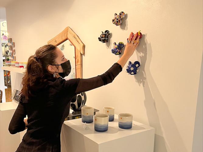 Erin Mangan installs artworks in a gallery