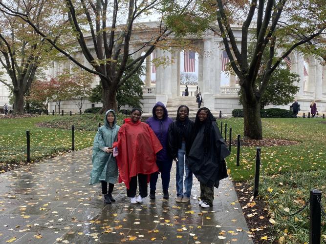 Trinh Nguyen, Kymiya Byars, Lisa Flowers-Clements, Christine Blay, and Aryn Monroe are shown at Arlington National Cemetery