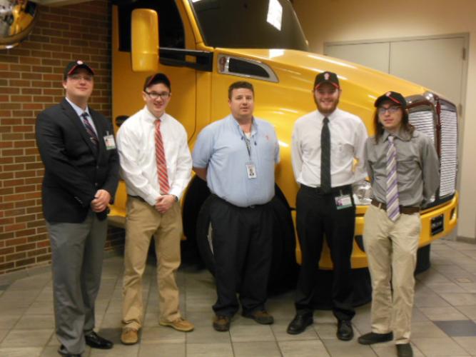 ISE students stand at Kenworth for their final presentation
