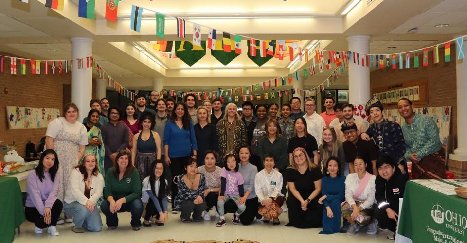 Students and staff members pose for a photo at the Global Education Fair at Athens High School