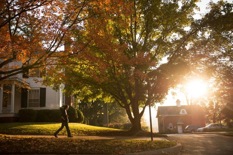 An individual walks on OHIO's Athens Campus during a fall afternoon