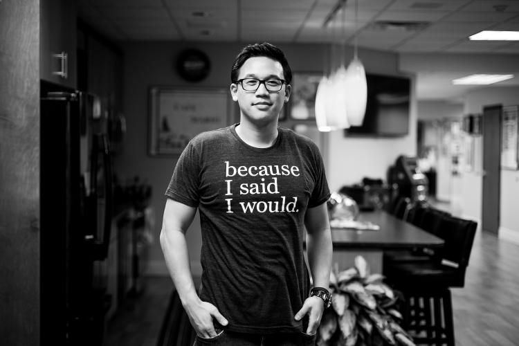 black and white headshot of Alex Sheen wearing 'because I said I would' shirt