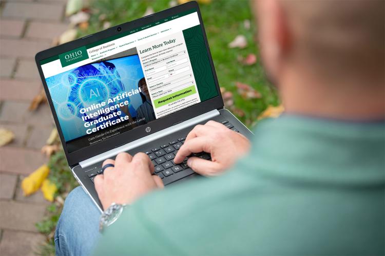 Student looking at the Artificial Intelligence Graduate Certificate webpage