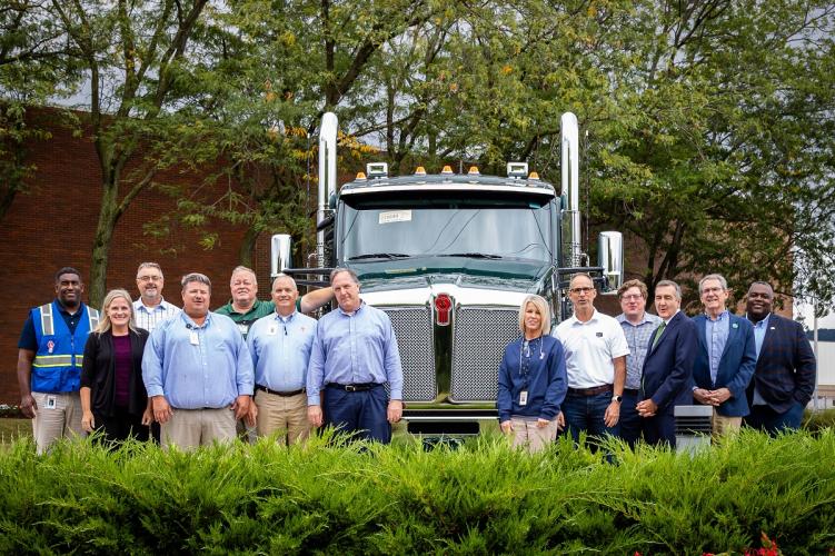 Representatives of Ohio University and Kenworth stand in front of a truck outside of the Chillicothe plant