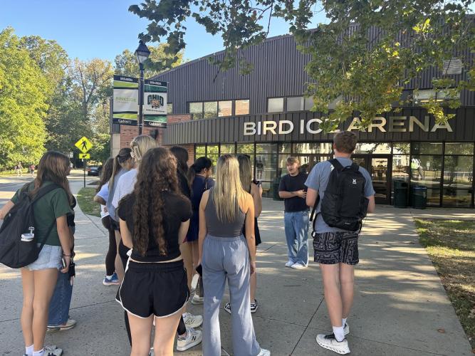 A Learning Community Leader shows first-year students the Bird Ice Arena