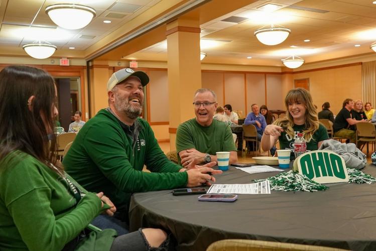 OHIO Dads and students laugh at a performance at Ohio University