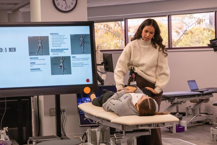 An MEA teaches medical students in the OMM lab