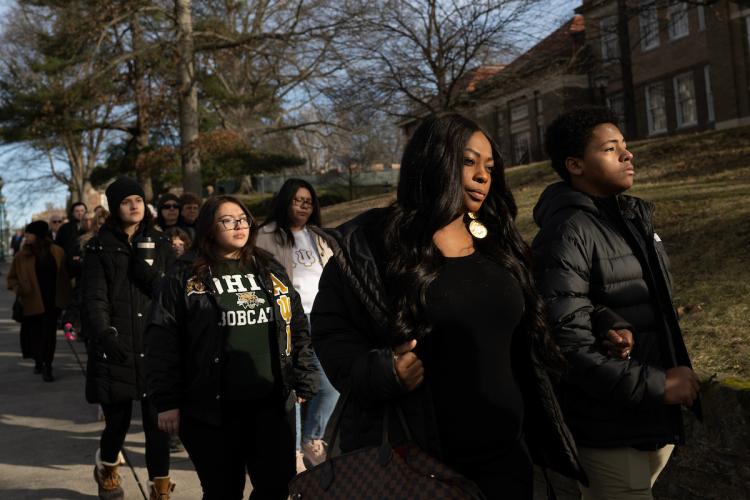 Participants link arms and walk in the MLK Silent March at Ohio University