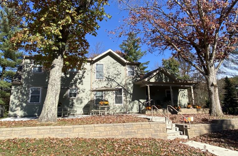 The outside of the Serenity Grove facility is shown on day in Fall
